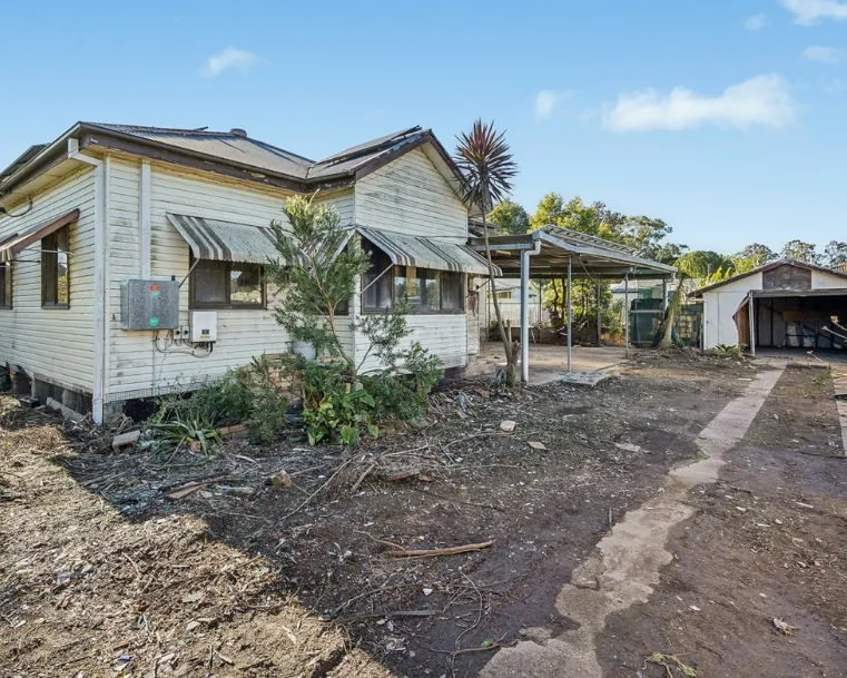 Large Adelaide property exterior with house, carport and separate shed awaiting clearance